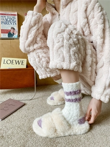 Detail of striped coral fleece socks paired with plush slippers and home wear