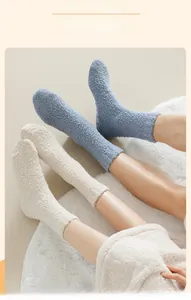 Detail of coral fleece thermal socks with anti-slip silicone dots on fluffy home carpet