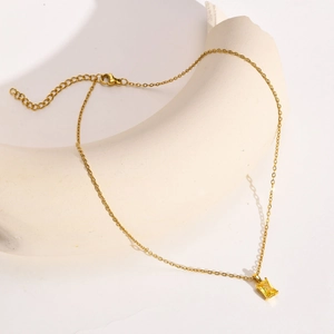 Detailed view of gold necklace featuring a rectangular yellow zircon pendant on a slim chain