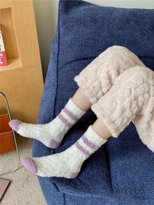 Detail of warm striped coral fleece socks showing soft plush texture and cozy winter style
