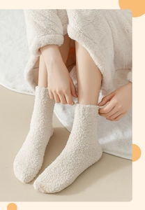 Close-up of thick beige coral fleece socks featuring soft texture and warm plush material