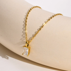 Close-up of rectangular white zircon pendant on a gold stainless steel chain