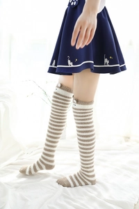 Détail de chaussettes hautes rayées en polaire corail avec oreilles de chat en peluche