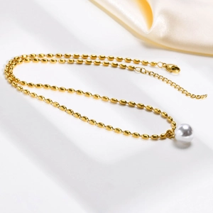 Gold stainless steel oval bead chain necklace featuring a large round white pearl pendant