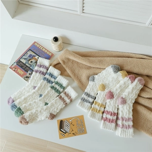 Detailed texture of thick coral fleece winter socks with colorful double stripes
