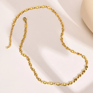 Gold stainless steel necklace featuring embossed sunburst metal discs and lobster clasp