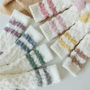 Detail of plush coral fleece thermal socks featuring various colors and double stripes