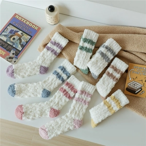 Close-up of soft coral fleece thermal socks with vibrant contrast stripes and plush texture