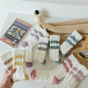 Macro detail of plush coral fleece striped thermal socks in multiple assorted colors