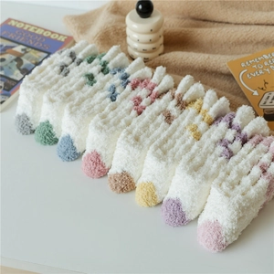 Close-up of soft coral fleece socks in various pastel colors for winter warmth