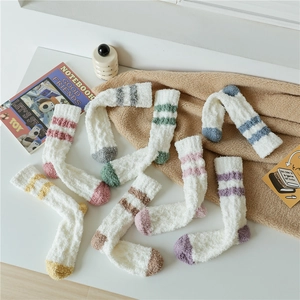 Close-up of cozy coral fleece socks in multiple pastel colors with sporty stripes