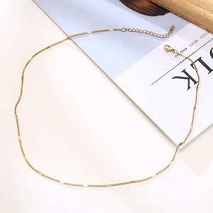 Detail of gold stainless steel necklace with rectangular tags and lobster clasp closure