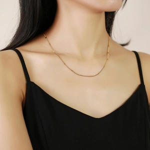 Minimalist gold stainless steel chain necklace for women displayed on a model