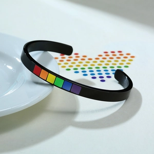 Macro detail of black C-shaped titanium steel bracelet with rainbow color blocks