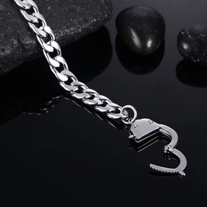 Detail view of silver Cuban link bracelet with unique handcuff style clasp and lock