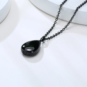Polished black teardrop urn pendant necklace with a subtle bottom seal and fine chain