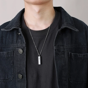 Close-up of a silver bar urn pendant with S925 engraving on a male model's neck