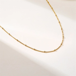Polished gold satellite chain necklace with 2mm beads in a minimalist layered style