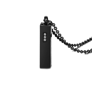 Detail view of a black rectangular cylinder urn pendant with three zircon stone inlays