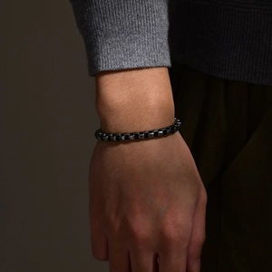 Close-up of a masculine dark silver box chain bracelet with square metal links