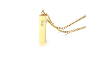 Close-up of golden rectangular urn pendant with three sparkling cubic zirconia stones