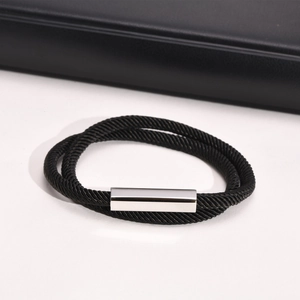 Detail of double-layer black Milan rope bracelet with polished silver magnetic clasp