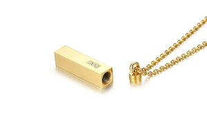 Detailed macro view of gold bar cremation pendant necklace with cubic zirconia stones