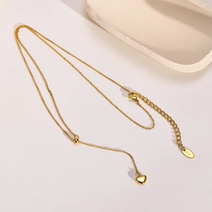 Golden titanium steel heart pendant necklace with K18 engraving and sliding bead detail