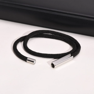 Detail shot of black braided double-layer rope bracelet with polished silver magnetic clasp