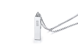 Macro detail of silver rectangular bar pendant with three vertically set cubic zirconia stones