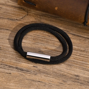 Detail of double-layer black braided rope bracelet with a polished silver magnetic clasp
