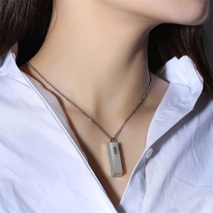 Close-up of a silver stainless steel rectangular cremation urn pendant with zircon inlay