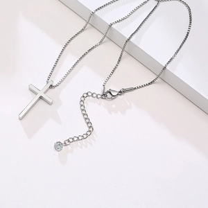 Detail of silver cross necklace with lobster clasp and cubic zirconia extension chain