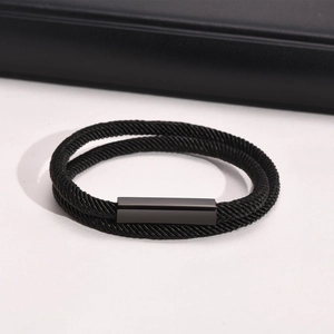 Detail of double-layer black braided rope bracelet with matte rectangular magnetic clasp