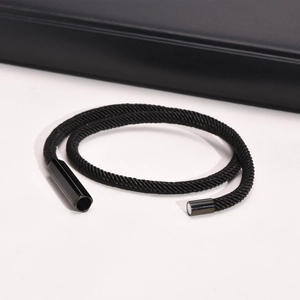 Close-up of black woven stainless steel bracelet with magnetic clasp detail