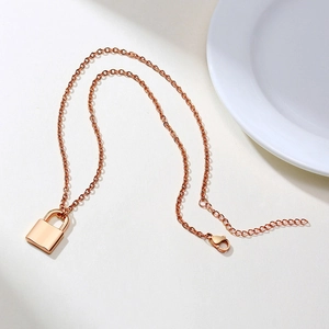 Detailed view of polished rose gold padlock pendant and adjustable cable chain
