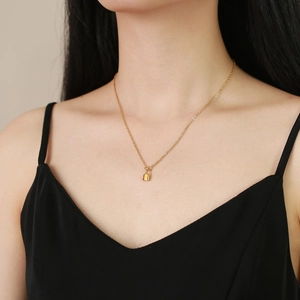 Minimalist gold stainless steel padlock necklace on model featuring a delicate O-chain