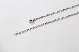 Detail view of the stainless steel lobster clasp and adjustable extension chain link