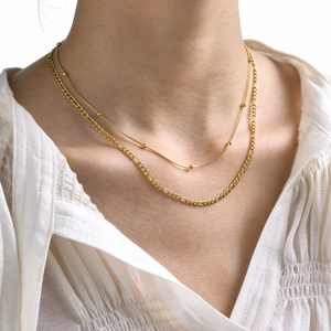 Double-layered golden stainless steel necklace with snake chain beads and Figaro chain