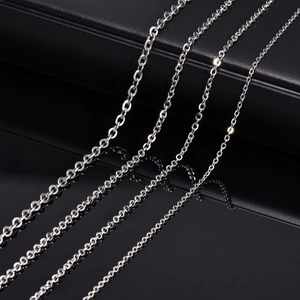 Set of four silver stainless steel link chains in different sizes on black background