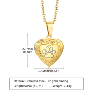 Detailed view of heart-shaped gold locket with paw print and vintage engraving