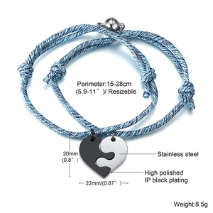 Macro detail of adjustable woven couple bracelets with magnetic heart stainless steel charm
