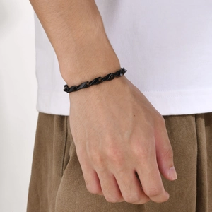 Men's minimalist black twisted curb link bracelet in stainless steel on wrist