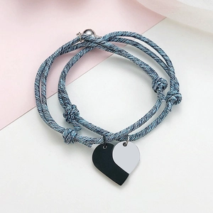 Detail of adjustable woven cord bracelets featuring magnetic heart-shaped pendants