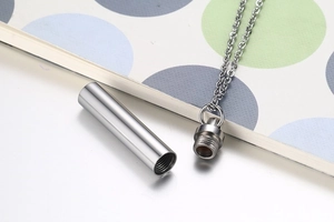 Detail of the screw-top mechanism and internal space of a polished cylinder perfume pendant
