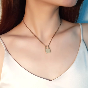 Polished gold padlock pendant necklace on stainless steel chain for women