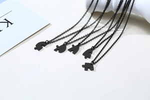 Detail of five interlocking heart puzzle pendants with matte black finish and matching chains