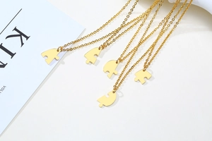 Set of five gold puzzle piece heart necklaces in polished stainless steel finish