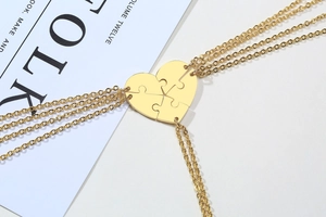 Close-up of five-piece gold heart puzzle pendant necklaces for friendship or family