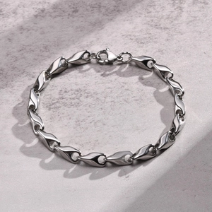 Detailed close-up of handmade stainless steel link chain with stylish teardrop metal links